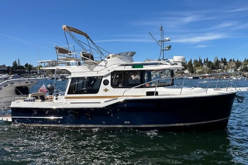 The Image of 2018 Ranger Tugs R-29 CB boat on water, sunny day, marina background. - 0