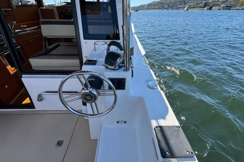 Slide: The Image of 2018 Ranger Tugs R-29 CB boat helm with scenic water view. - 10