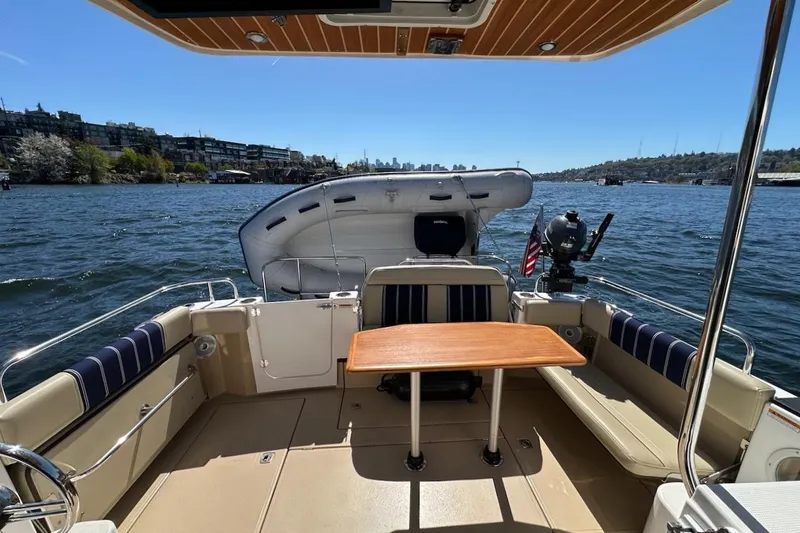 Slide: The Image of 2018 Ranger Tugs R-29 CB boat interior with table, on a sunny day by the water. - 11