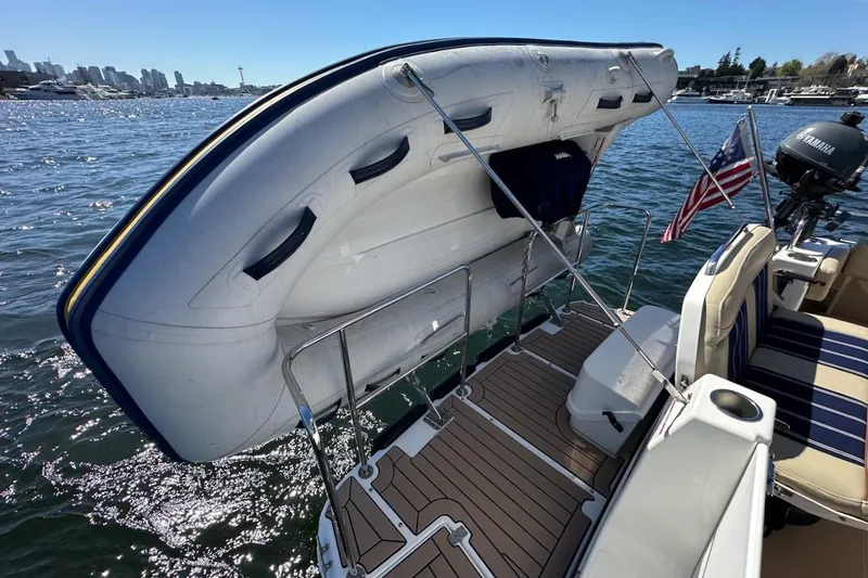Slide: The Image of 2018 Ranger Tugs R-29 CB with dinghy on deck, American flag, and Yamaha motor. - 16