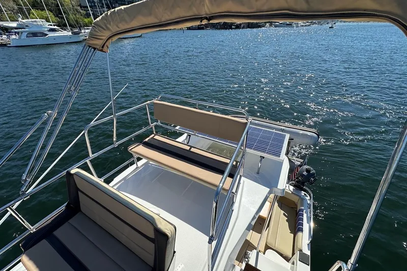 Slide: The Image of 2018 Ranger Tugs R-29 CB boat deck with seating, overlooking calm water. - 19