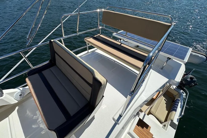 Slide: The Image of 2018 Ranger Tugs R-29 CB boat deck with seating and solar panels on water. - 20