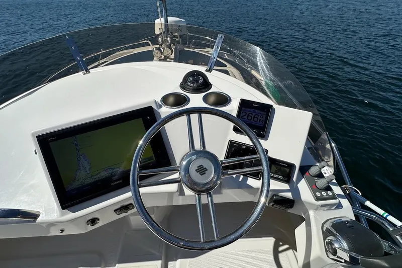 Slide: The Image of Cockpit view of 2018 Ranger Tugs R-29 CB with navigation equipment and steering wheel. - 22