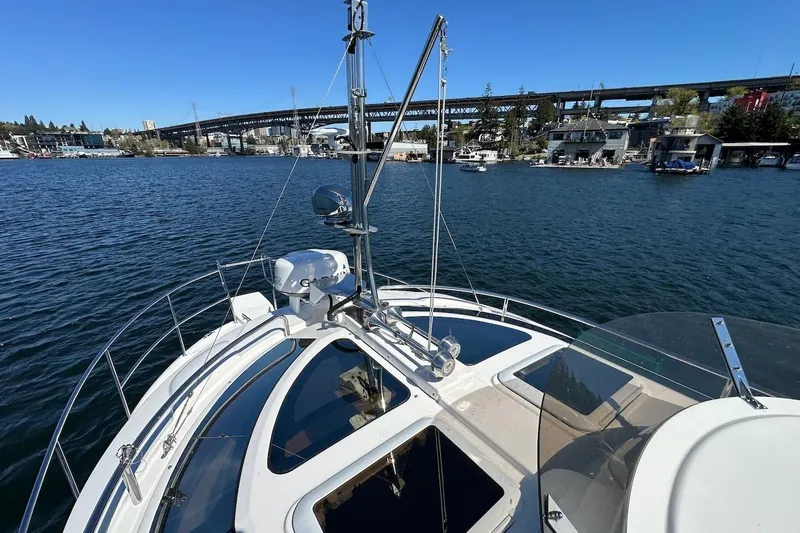 Slide: The Image of 2018 Ranger Tugs R-29 CB boat on a scenic waterway with bridge and marina views. - 23