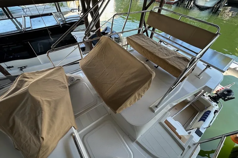 Slide: The Image of 2018 Ranger Tugs R-29 CB boat deck with covered seating and railing. - 24