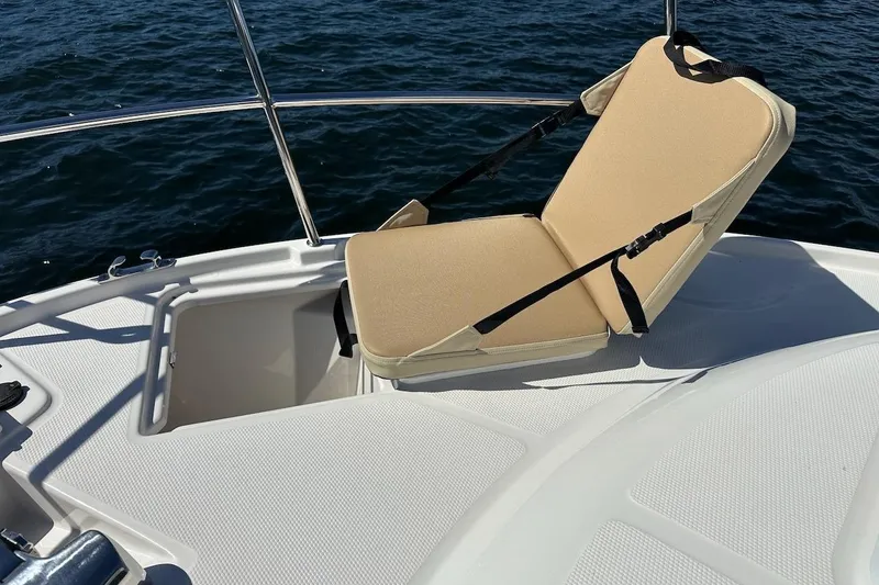 Slide: The Image of 2018 Ranger Tugs R-29 CB boat deck with beige seat, overlooking water. - 26