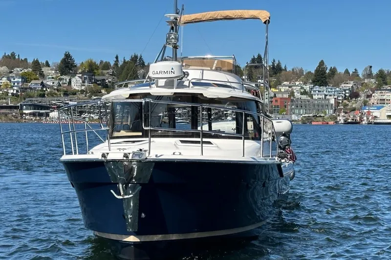 Slide: The Image of 2018 Ranger Tugs R-29 CB boat on water, cityscape background. - 3