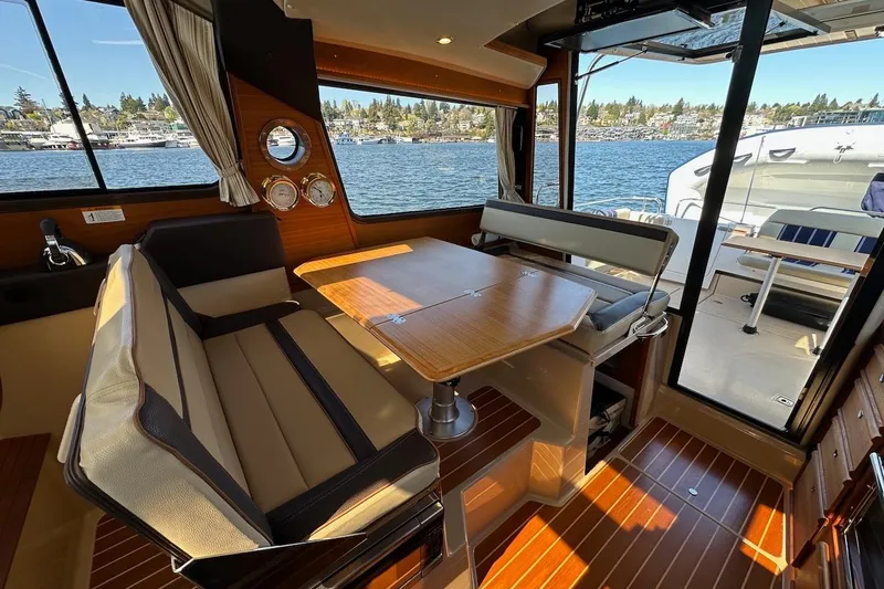 Slide: The Image of Interior of 2018 Ranger Tugs R-29 CB boat with dining area and scenic water view. - 30