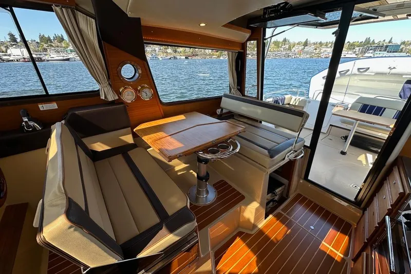 Slide: The Image of Interior of 2018 Ranger Tugs R-29 CB boat with seating and table, overlooking water. - 31