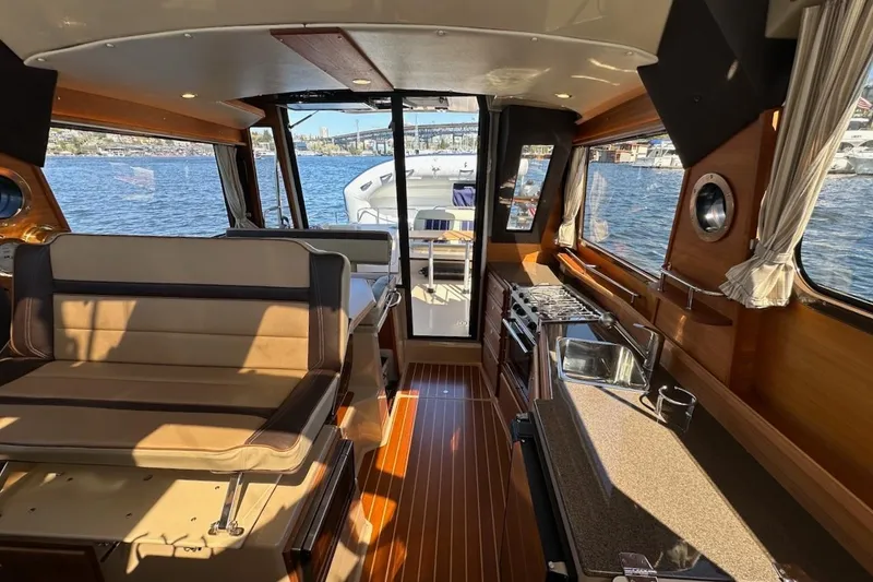 Slide: The Image of Interior of 2018 Ranger Tugs R-29 CB boat with kitchen and seating area. - 32