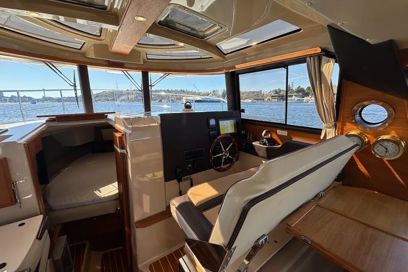 Slide: The Image of Interior of 2018 Ranger Tugs R-29 CB boat with helm, seating, and scenic water view. - 34