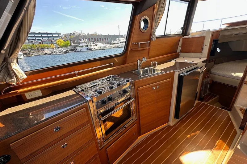 Slide: The Image of Interior of 2018 Ranger Tugs R-29 CB yacht with kitchen and waterfront view. - 39