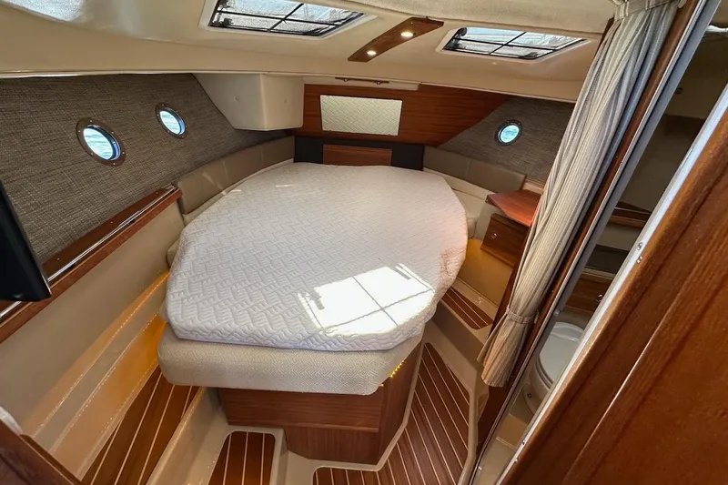 Slide: The Image of Cozy cabin interior of 2018 Ranger Tugs R-29 CB with a neatly made bed. - 41