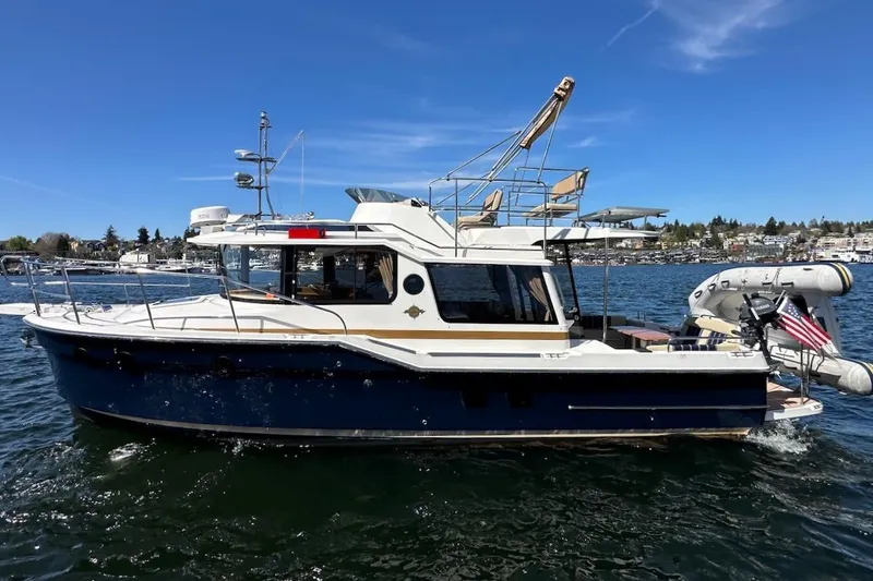 Slide: The Image of 2018 Ranger Tugs R-29 CB cruising on a sunny day with clear blue skies. - 5