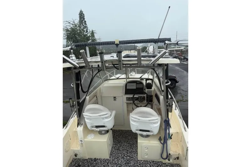 Slide: The Image of 1998 World Cat 266 SC boat interior with dual seats and steering console. - 2