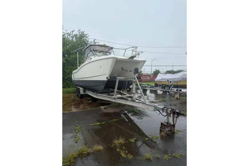 Slide: The Image of 1998 World Cat 266 SC boat on trailer in outdoor setting. - 3