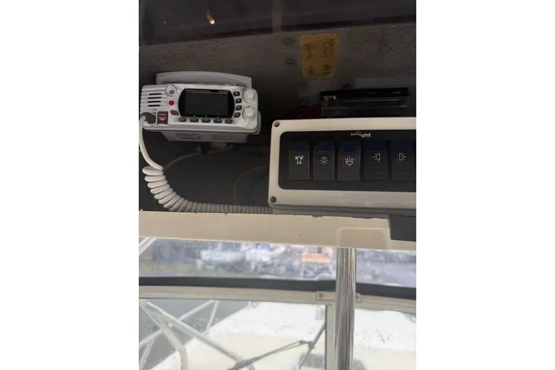 Slide: The Image of 1998 World Cat 266 SC boat dashboard with radio and control panel. - 4