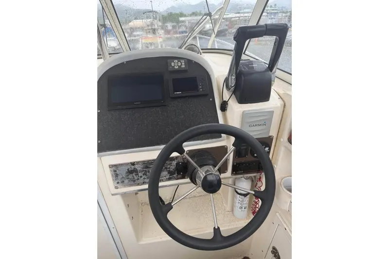 Slide: The Image of 1998 World Cat 266 SC boat helm with Garmin navigation and steering wheel. - 5