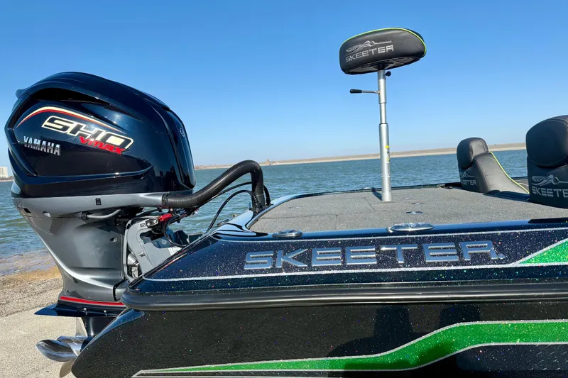 Slide: The Image of 2022 Skeeter ZX225 boat with Yamaha SHO VMAX engine by the water. - 13
