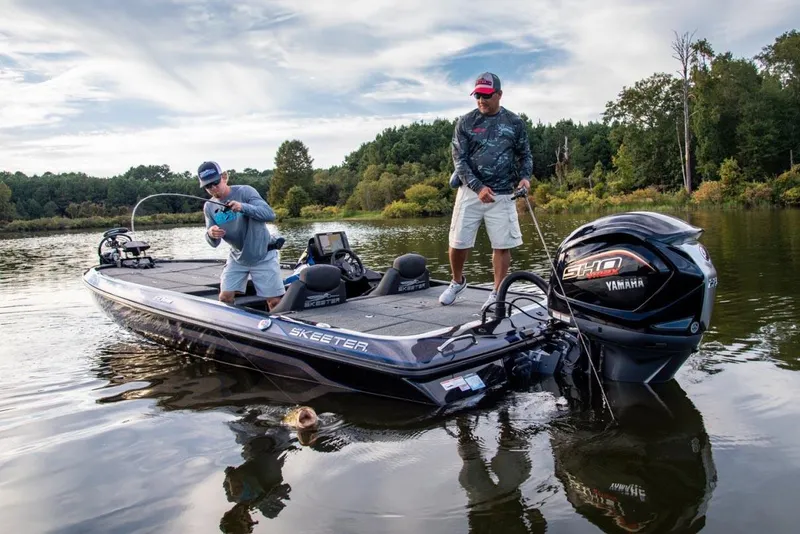 Slide: The Image of Manufacturer Provided Image: 2022 Skeeter ZX 225 boat on a lake with two people fishing. - 16