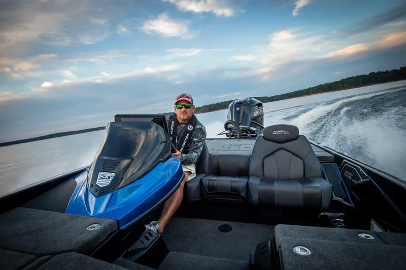 Slide: The Image of Manufacturer Provided Image: Man driving 2022 Skeeter ZX 225 boat on a lake at sunset. - 18