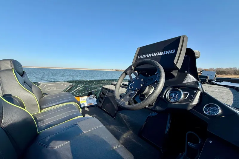 Slide: The Image of 2022 Skeeter ZX225 boat interior with Humminbird electronics, steering wheel, and comfortable seating. - 5
