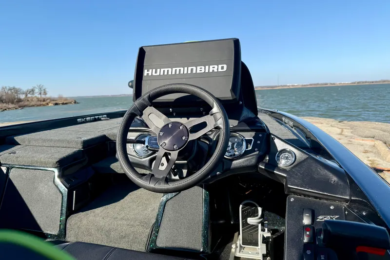 Slide: The Image of 2022 Skeeter ZX225 boat with Humminbird electronics, steering wheel, and lake view. - 6
