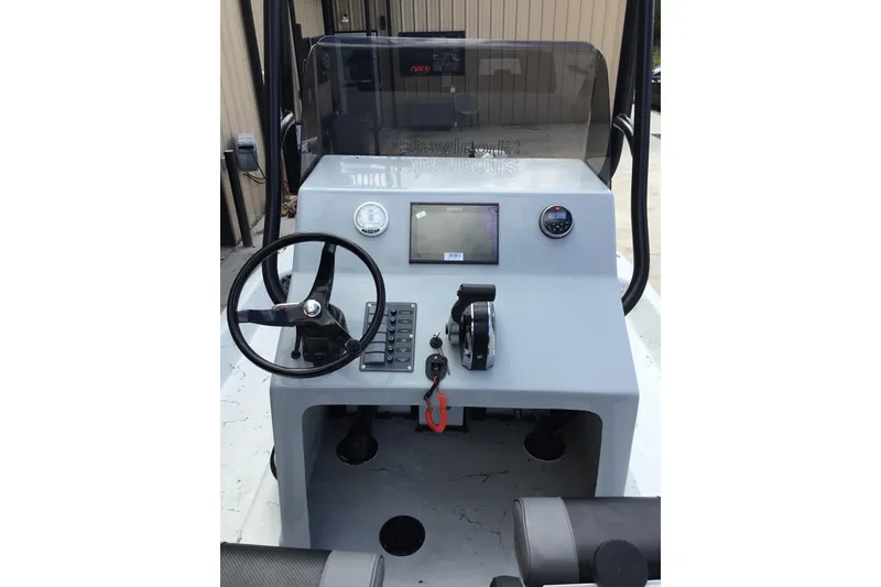 Slide: The Image of Helm of 2015 Shoalwater 23' Catamaran with steering wheel and control panel. - 4