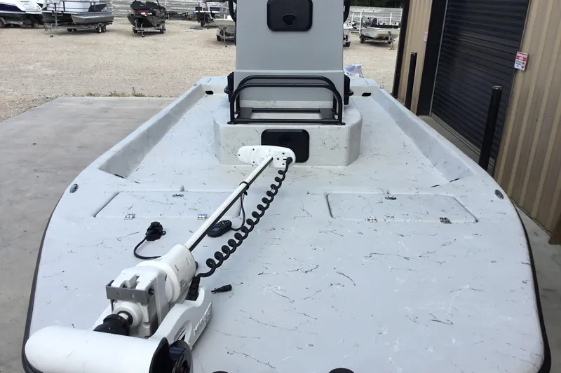 Slide: The Image of 2015 Shoalwater 23' Catamaran with trolling motor, docked near storage facility. - 7