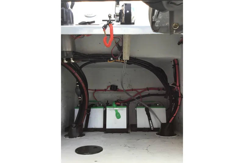 Slide: The Image of Battery compartment of a 2015 Shoalwater 23' Catamaran with wiring and components. - 8