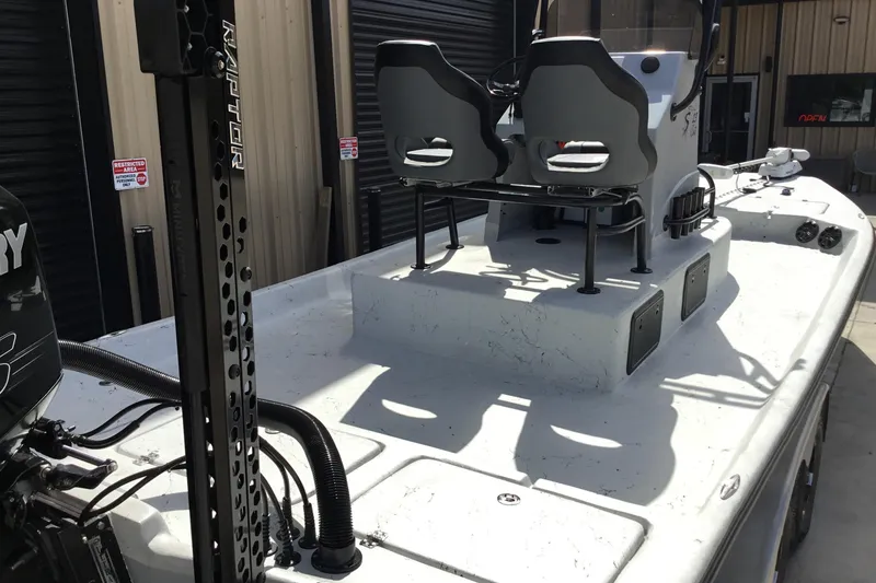 Slide: The Image of 2015 Shoalwater 23' Catamaran with dual seats and Mercury engine, docked outdoors. - 9