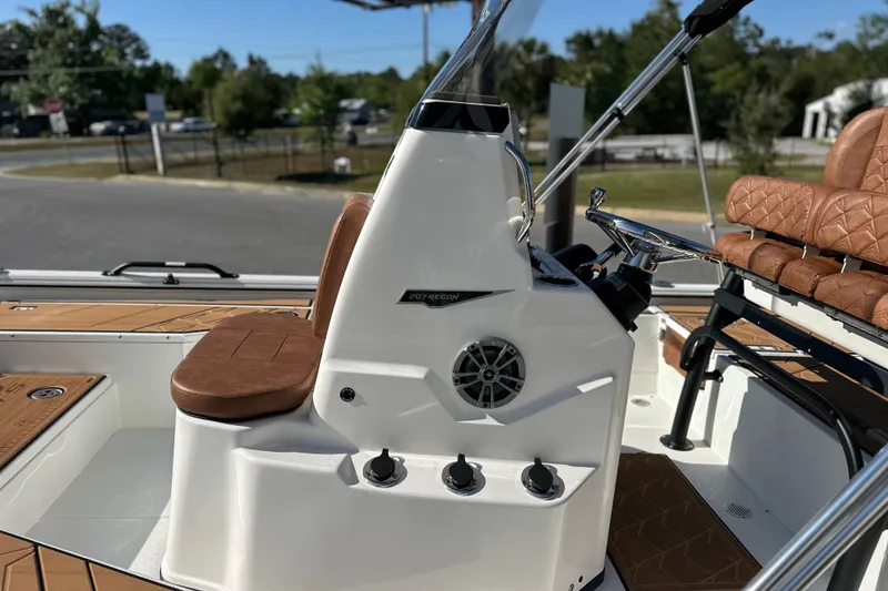 Slide: The Image of 2026 Avid 207 Recon boat interior with brown leather seating and modern controls. - 10