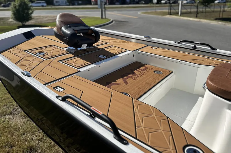 Slide: The Image of 2026 Avid 207 Recon boat with sleek wooden deck and comfortable seating. - 13