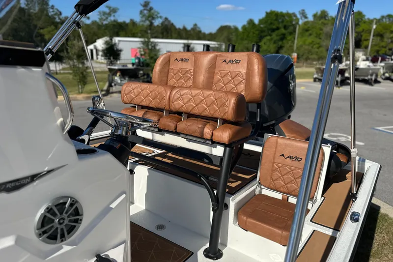 Slide: The Image of 2026 Avid 207 Recon boat with brown leather seating and sleek design. - 14