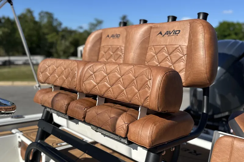 Slide: The Image of Luxurious brown leather seats on 2026 Avid 207 Recon boat, featuring diamond stitching. - 2