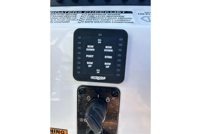 Slide: The Image of Control panel of Avid 207 Recon 2026 boat with trim tab settings. - 20