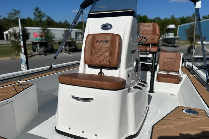 Slide: The Image of 2026 Avid 207 Recon boat with brown leather seating and sleek white console. - 22