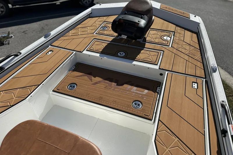 Slide: The Image of Avid 207 Recon 2026 boat interior with stylish wood-patterned deck and seating. - 23