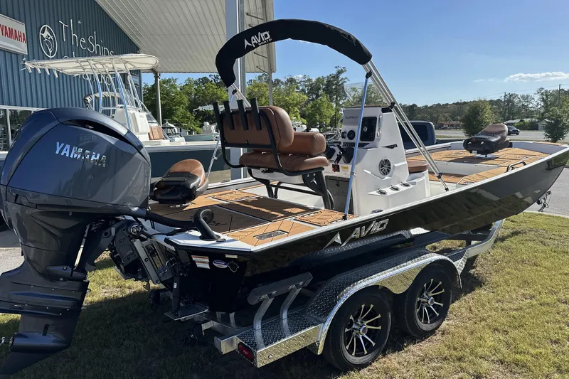 Slide: The Image of 2026 Avid 207 Recon boat with Yamaha engine on a trailer, parked outdoors. - 4