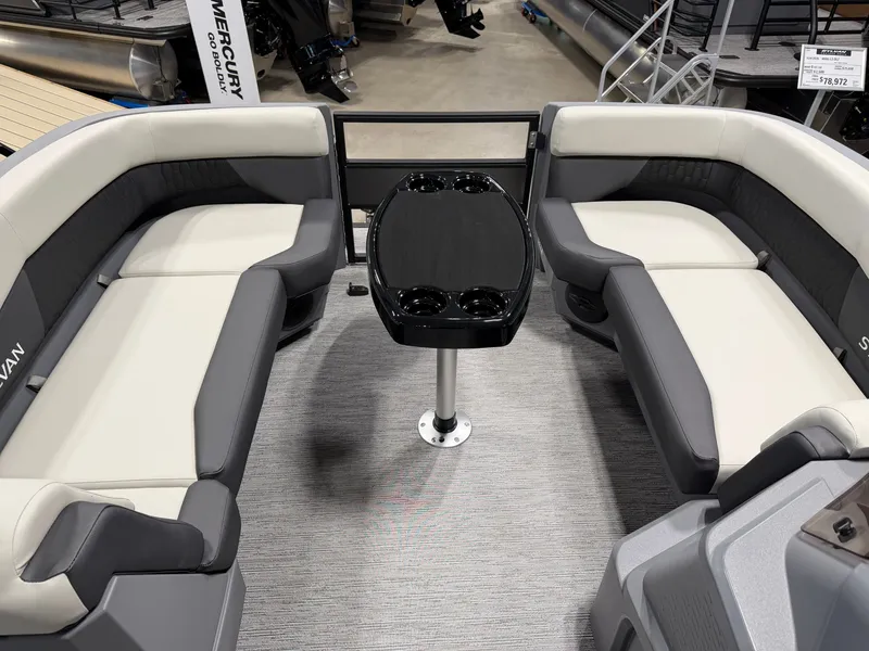 Slide: The Image of The image shows the interior of a 2027 Sylvan R-20 Q DH boat with gray and white seating. - 8