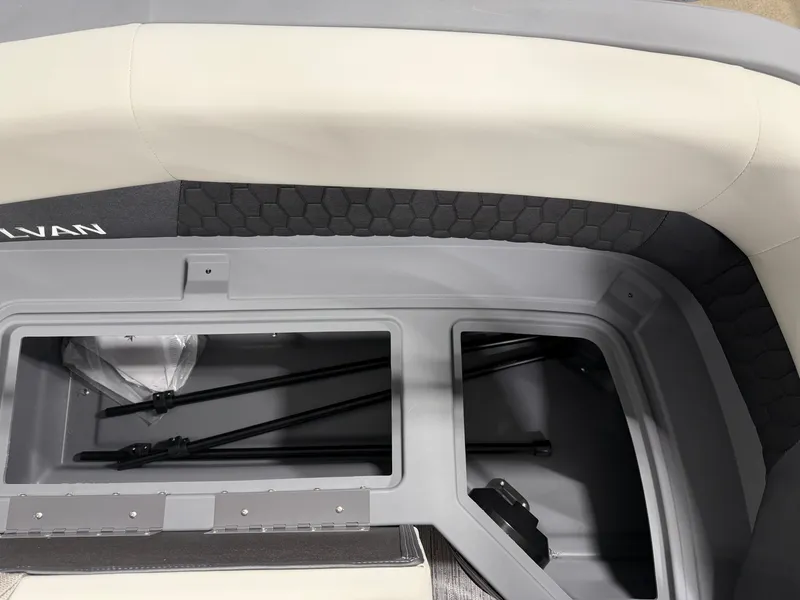 Slide: The Image of The image shows the storage area of a 2027 Sylvan R-20 Q DH boat with gray and black upholstery. - 7