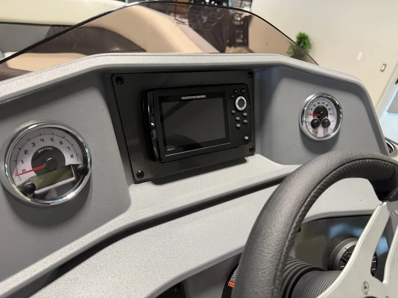 Slide: The Image of The image shows the dashboard of a Sylvan R-20 Q DH boat with a navigation system. - 12