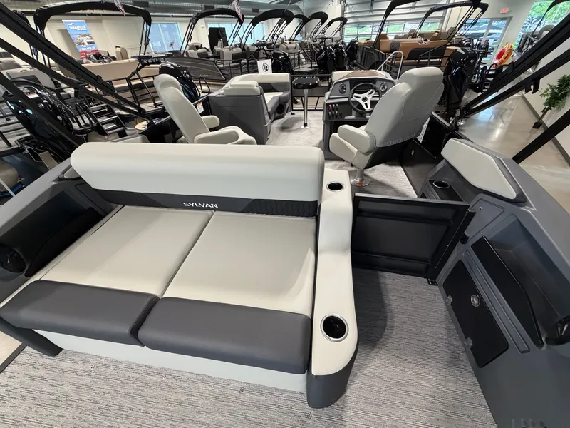 Slide: The Image of The image shows the interior of a 2027 Sylvan R-20 Q DH boat with modern seating. - 19