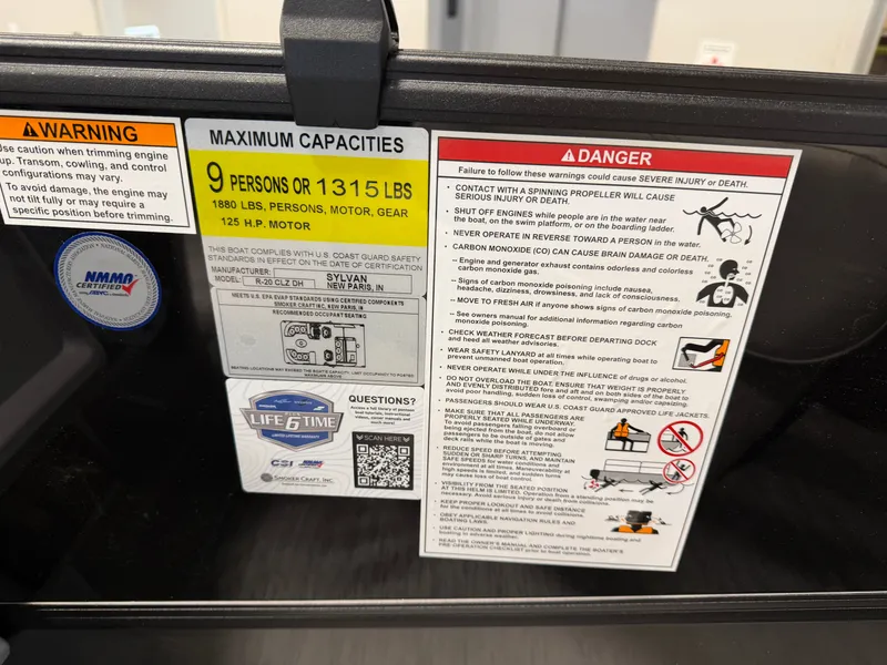 Slide: The Image of Safety and capacity labels on a 2027 Sylvan R-20 Q DH boat. - 14