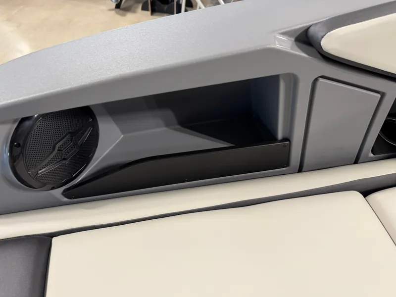Slide: The Image of Close-up of a gray and white boat interior with a speaker and storage compartment. - 21