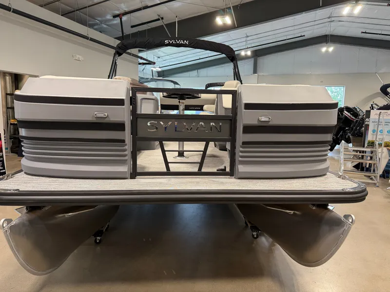 Slide: The Image of A 2027 Sylvan R-20 Q DH pontoon boat is in a showroom. It features a modern design. - 1