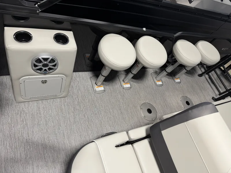 Slide: The Image of The image shows a modern boat cabin with white bar stools and a speaker. - 20