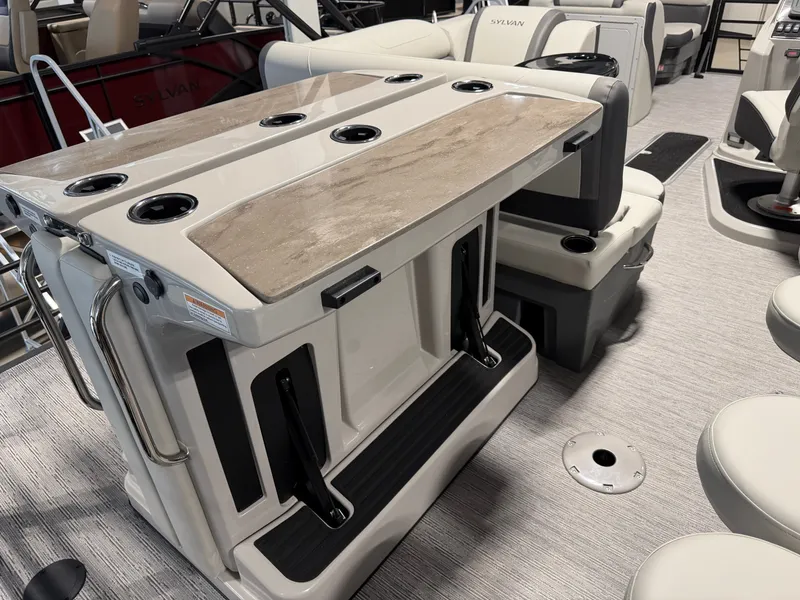 Slide: The Image of The image shows the interior of a 2026 Sylvan MIRAGE X3 DLZ BAR with a bar and seating area. - 22