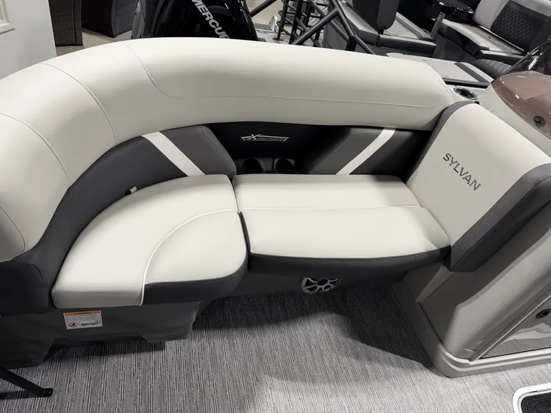 Slide: The Image of The image shows an elegant, upholstered seating area in a Sylvan boat, model MIRAGE X3 DLZ BAR, year 2026. - 8