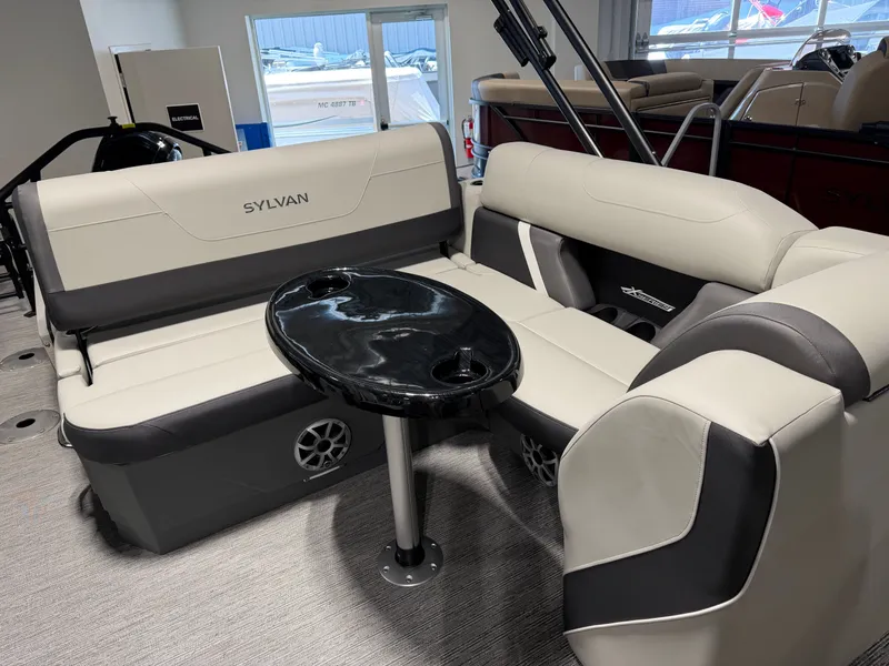 Slide: The Image of Interior of a 2026 Sylvan MIRAGE X3 DLZ BAR with sleek seating and a table. - 19